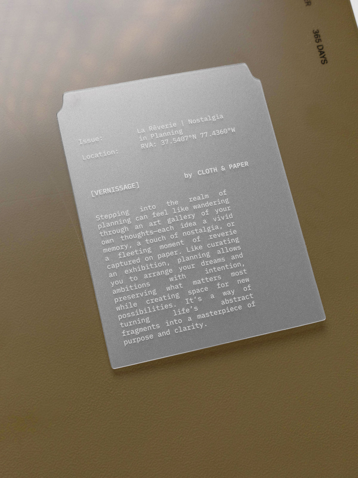 White printed text on unpunched page marker resting on a perfect bound notebook.