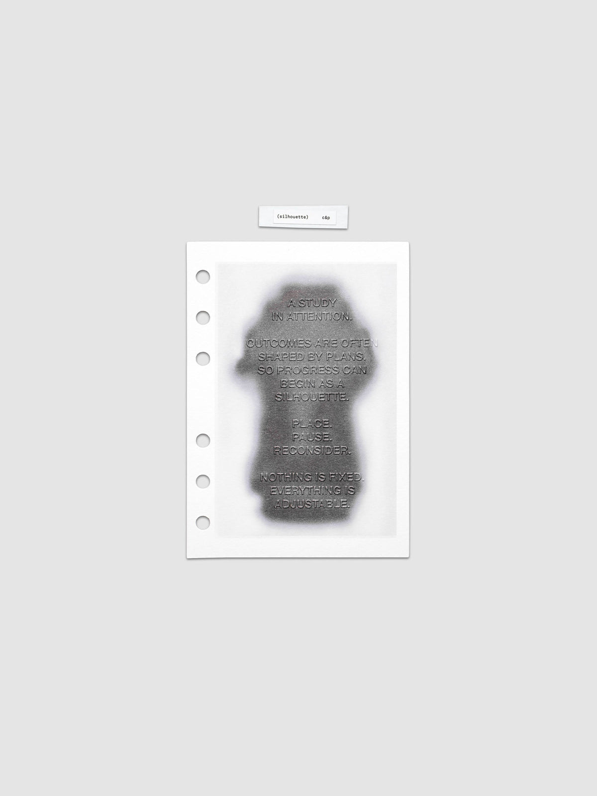 Silhouette Planner Dashboard in A6. Greyscale silhouette print with embossed text on paper. Image 1 of 2.