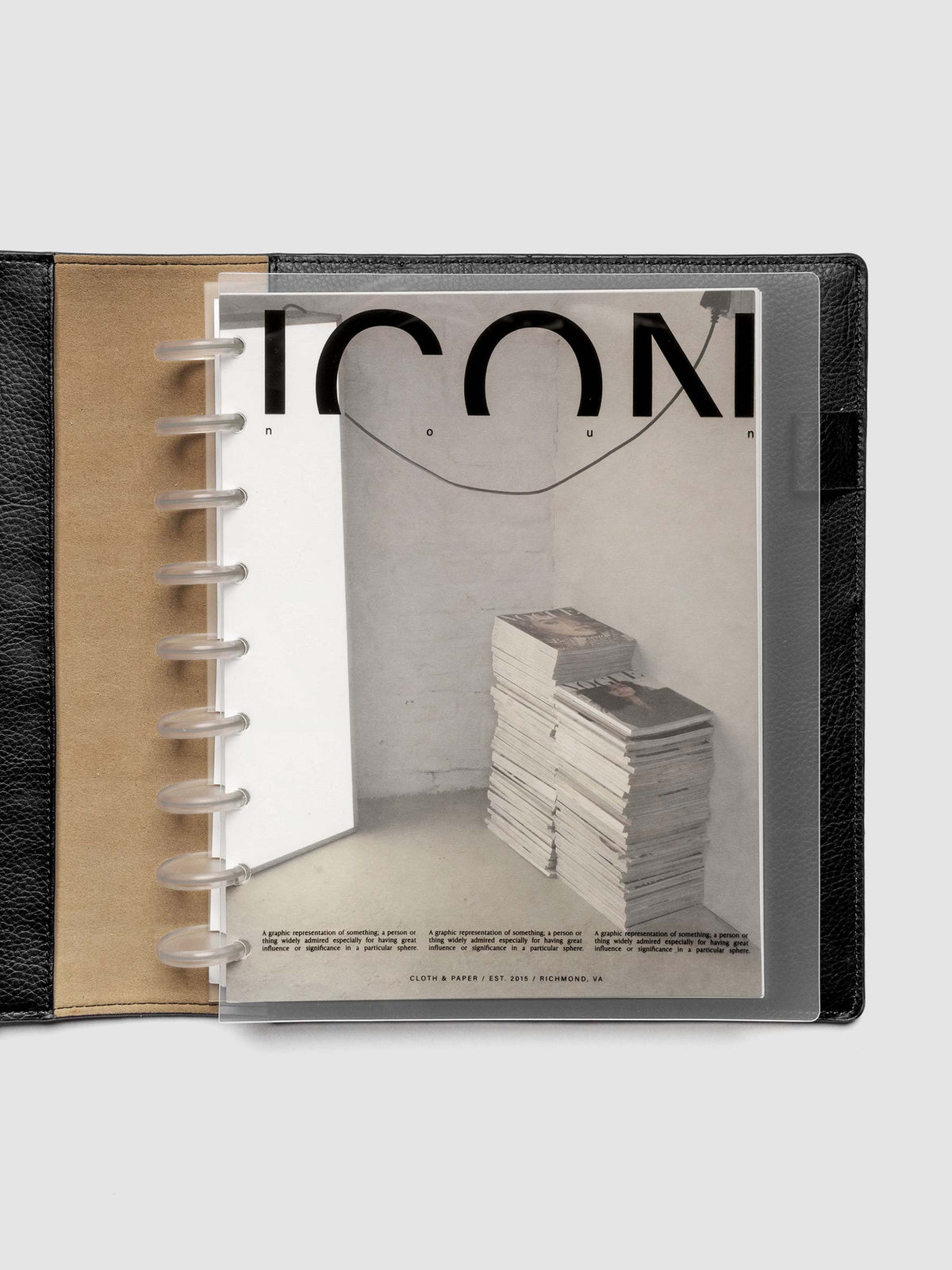 Clear planner cover with black text and a photographic dashboard shown pre-punched for discbound planners in size HP Classic in a black folio.