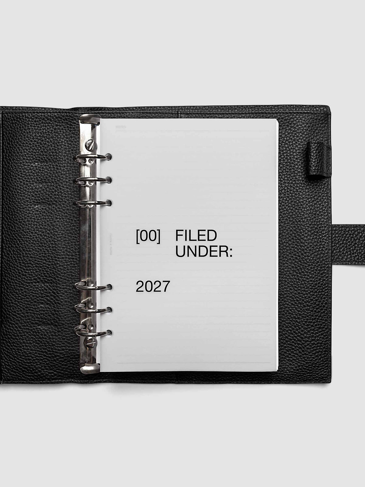 2027 Front + Monthly Dashboard Overlays, Avant Garde, A5 6-Ring Punch, vellum dashboard overlay shown layered inside a planner