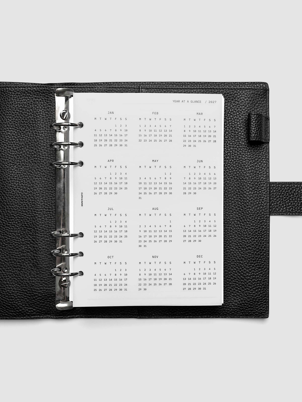 2027 Year At A Glance Dashboard Monday Start, Half Letter 8-Disc Punch, close-up of the top right corner of the vellum dashboard showing calendar month detail and Monday-start grid layout