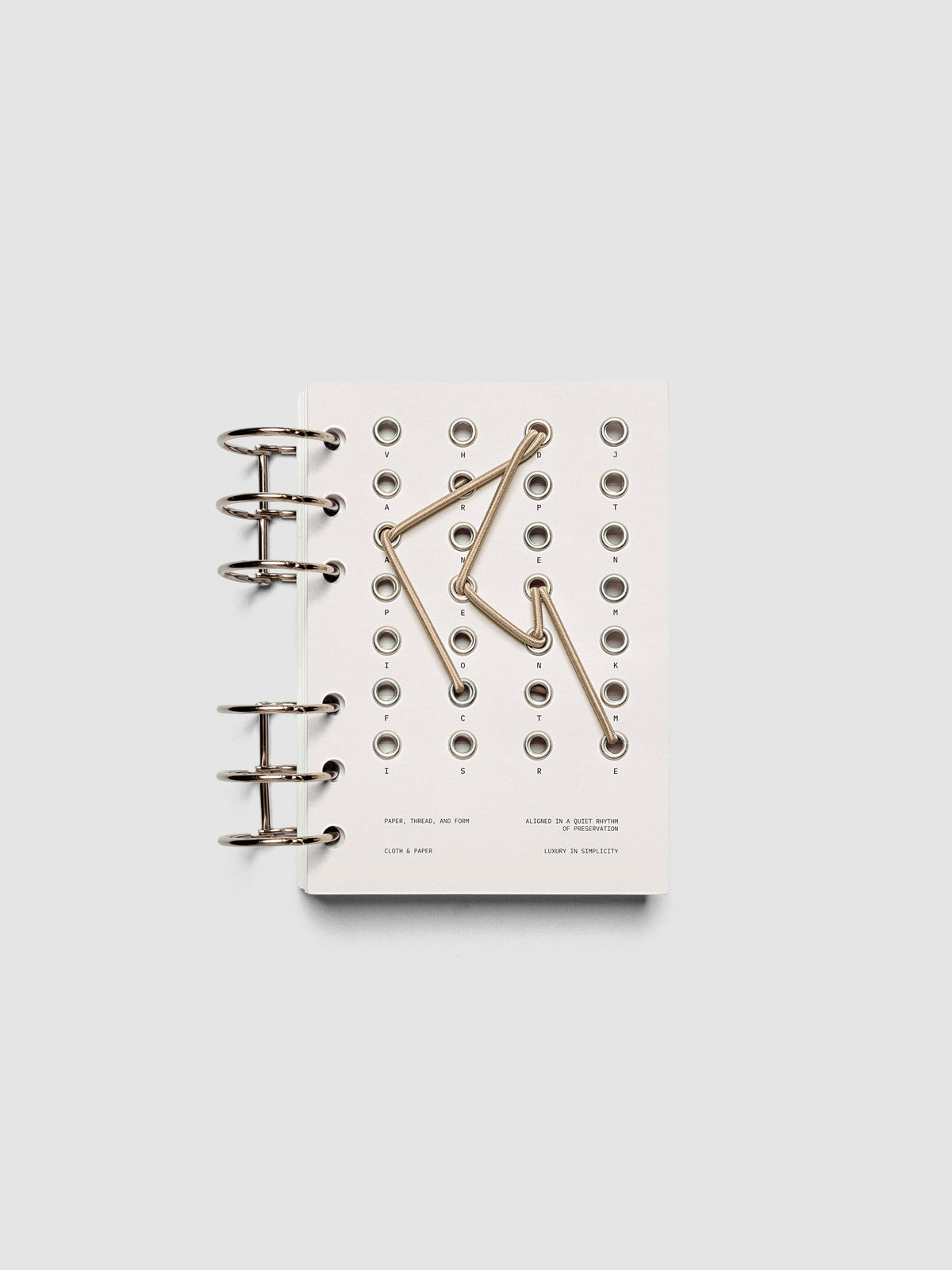 Cadence Dashboard with grommets and string on beige cardstock shown in size A6 for 6-ring planners and notebooks.