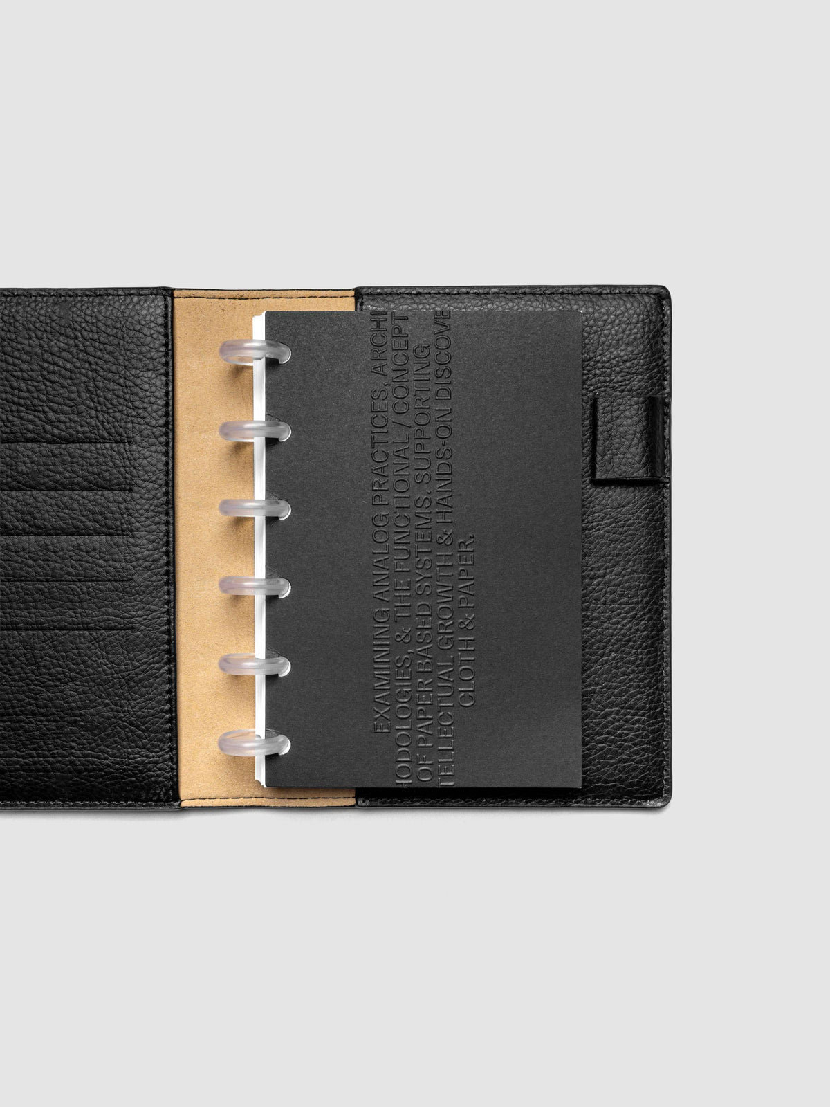 Black embossed Analog Embossed Planner Dashboard without the drop card shown in size CP Petite.