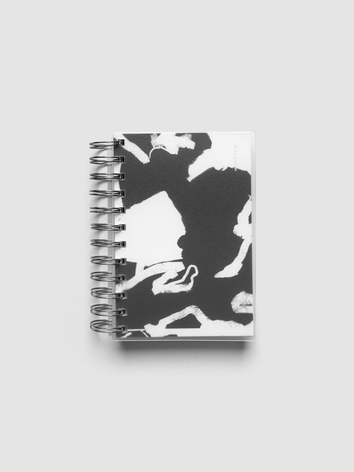 Spiral Notebook dashboard in the pattern Drybrush shown in size CP Petite inside a notebook with the frosted transparent cover overlayed.