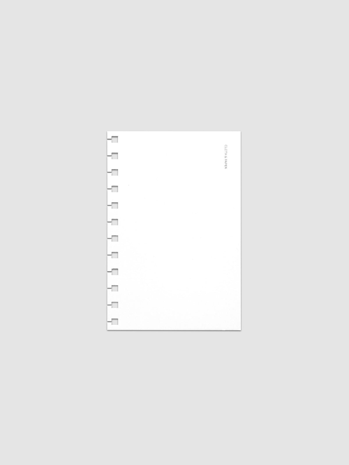 Spiral Notebook dashboard in the color Le Blanc shown in size CP Petite against a neutral background.