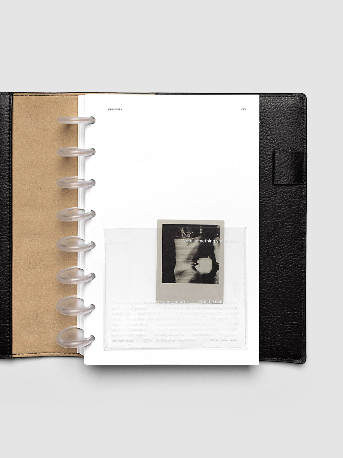 White Ephemera Planner Dashboard shown in size Half Letter in a black leather folio.