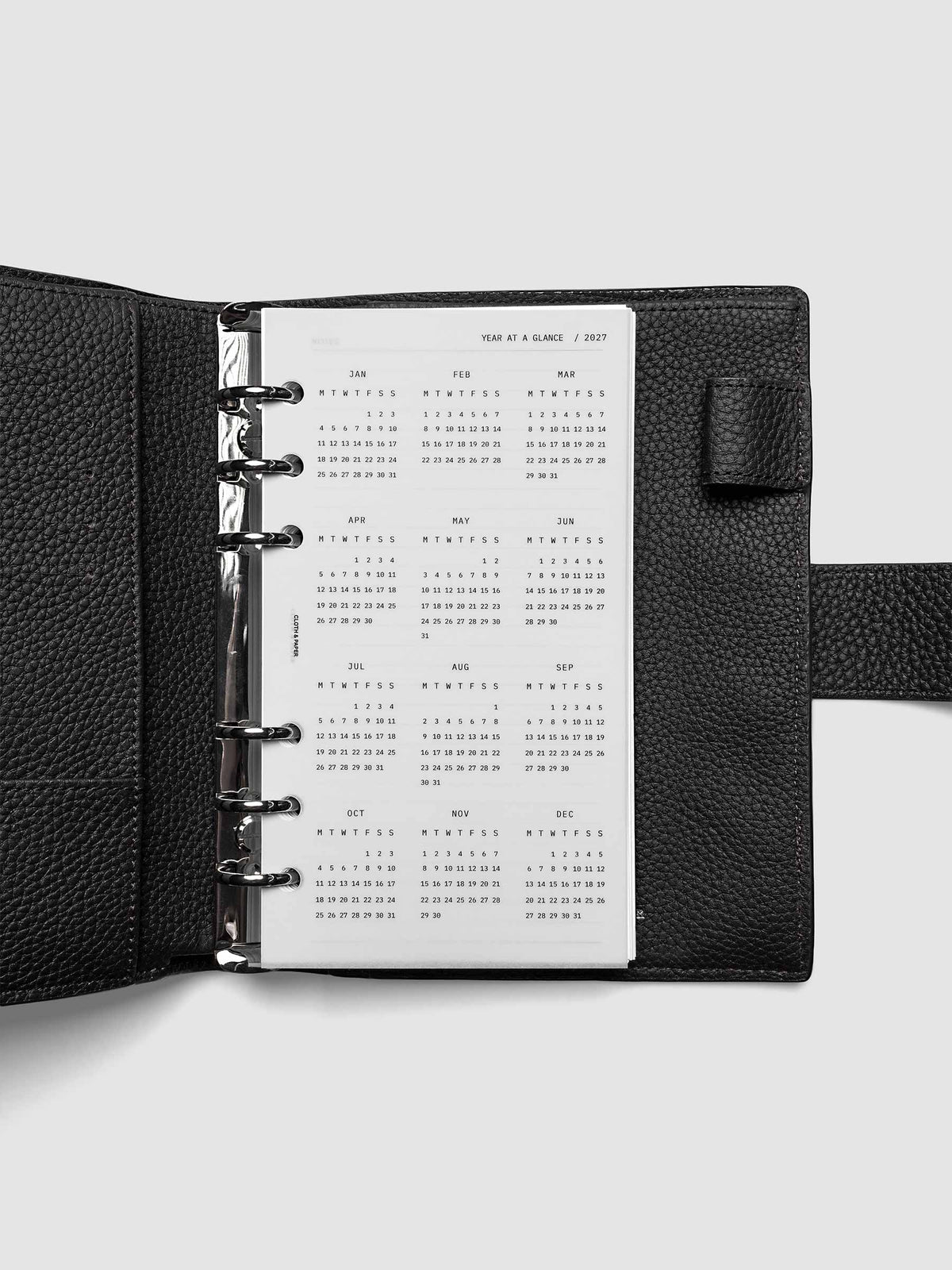 2027 Year At A Glance Dashboard Monday Start, Personal 6-Ring Punch, translucent vellum year-at-a-glance calendar shown inside a planner