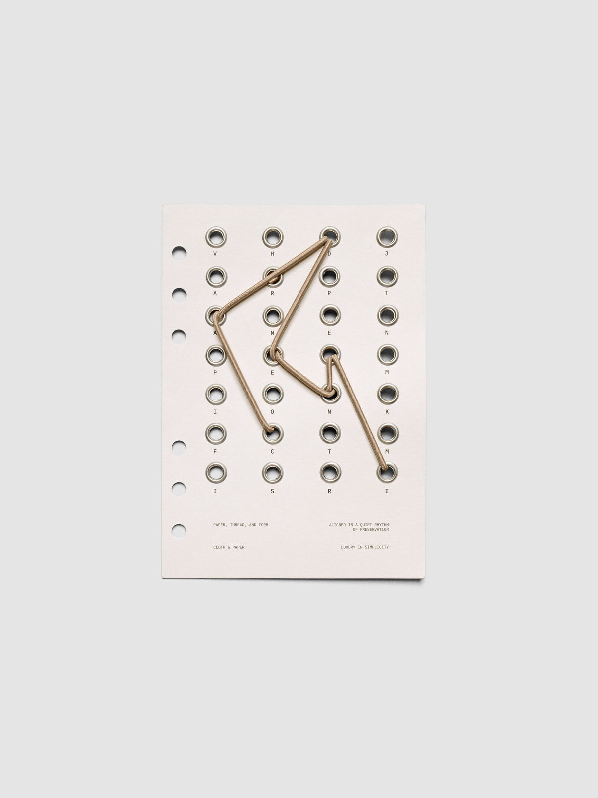 Cadence Dashboard with grommets and string on beige cardstock shown in size Personal Wide for 6-ring planners and notebooks.