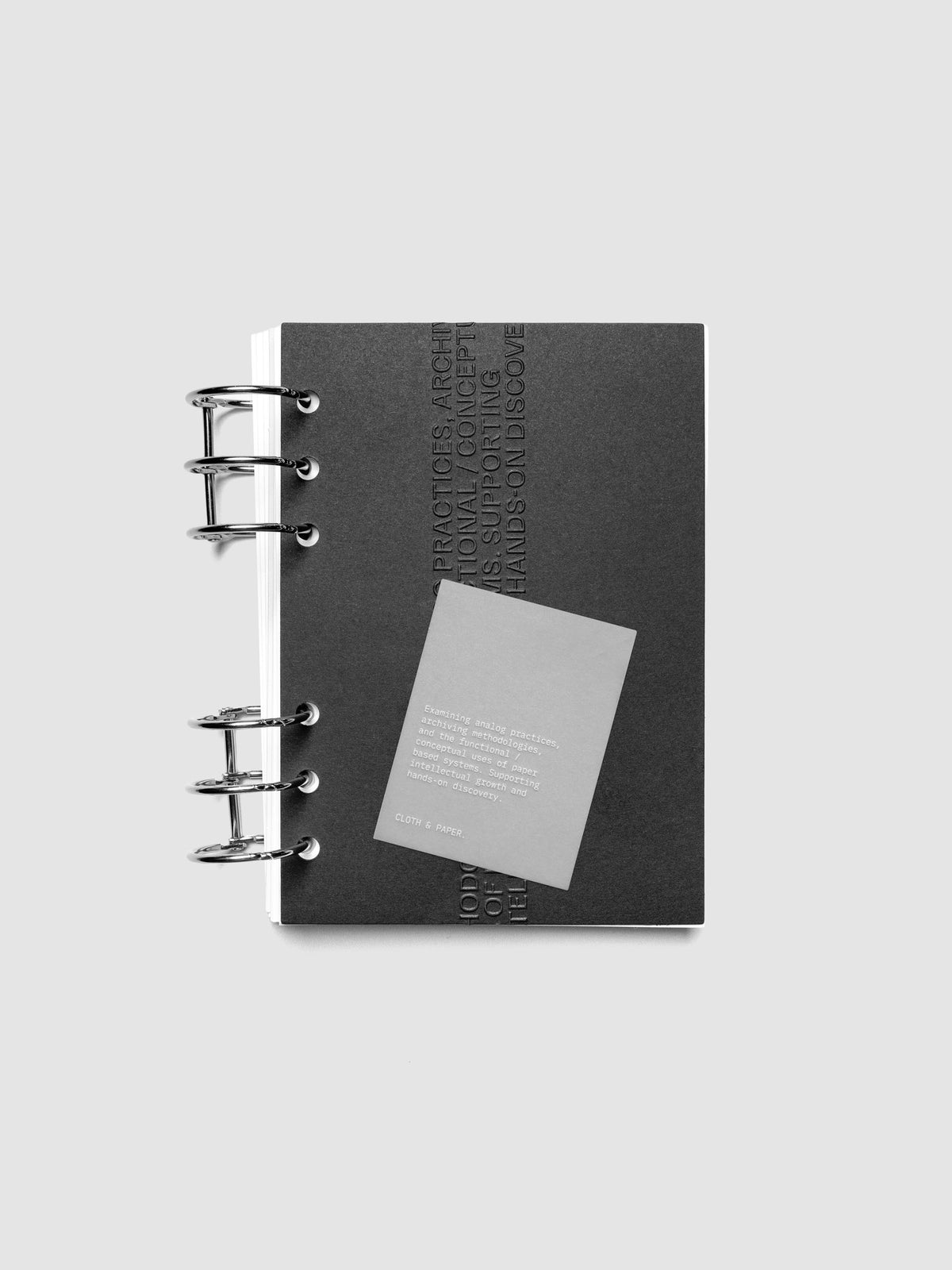 Black embossed Analog Embossed Planner Dashboard with drop card shown in size Personal Wide.