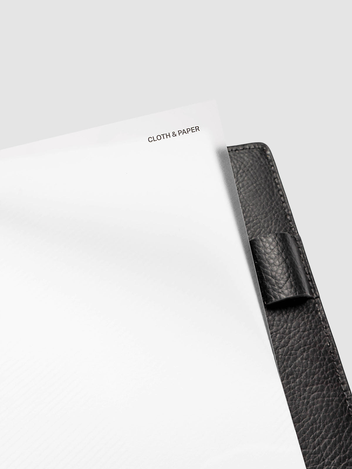 Folded Collage Planner Dashboard, Half Letter 8-Disc Punch, close-up detail showing the top clear plastic layer lifted at the right corner