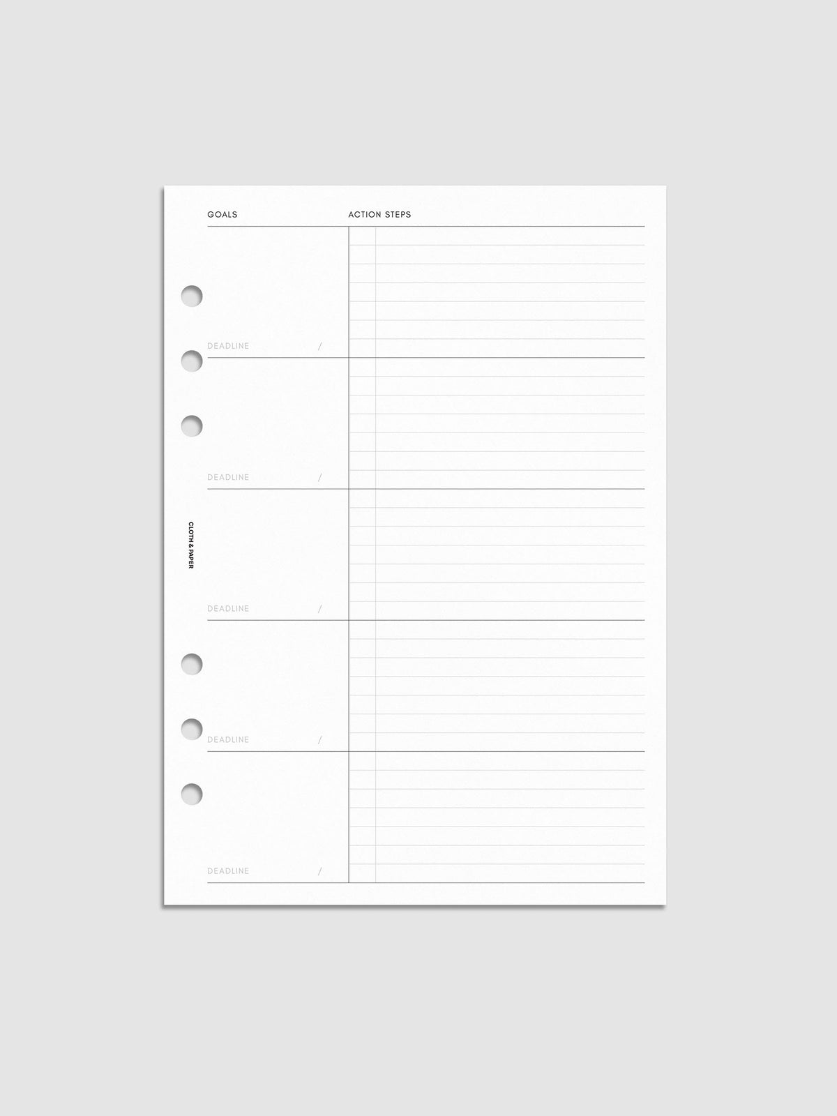 A blank planner page with sections for goals, deadlines, and action steps, featuring six holes for binder insertion. The left side has labeled boxes for goals and deadlines, while the right side has lined space for action steps.
