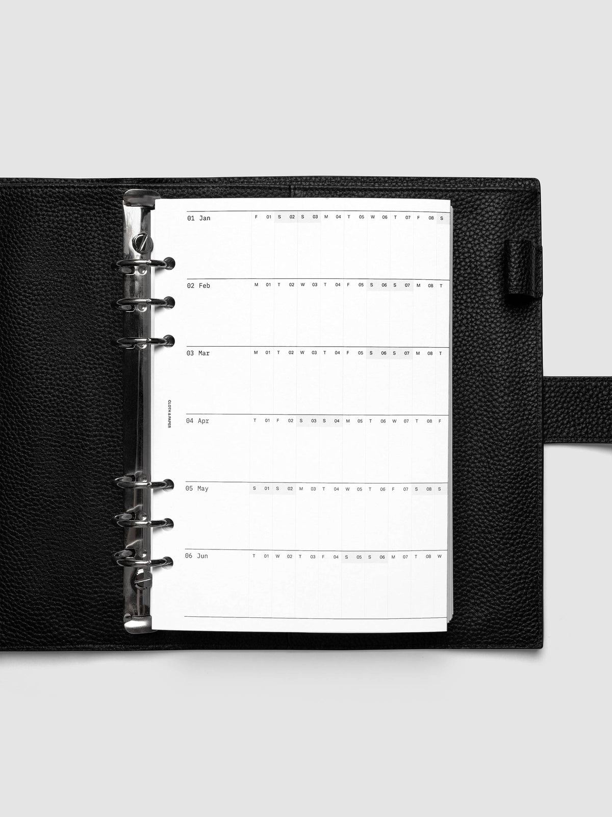 2027 Dated Fold Out Insert tucked into a A5 6-Ring Punch 6-ring planner, shown closed.