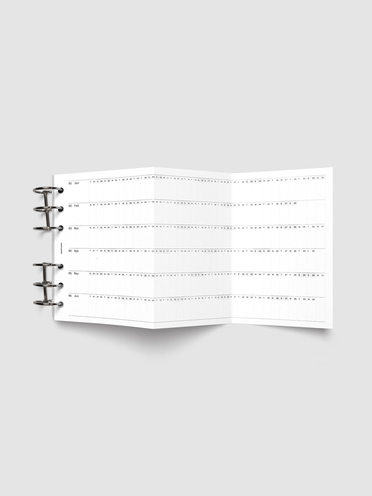 2027 Dated Fold Out Insert fully unfolded inside a A6 6-Ring Punch 6-ring planner, showing six months of dated calendar boxes across one side.