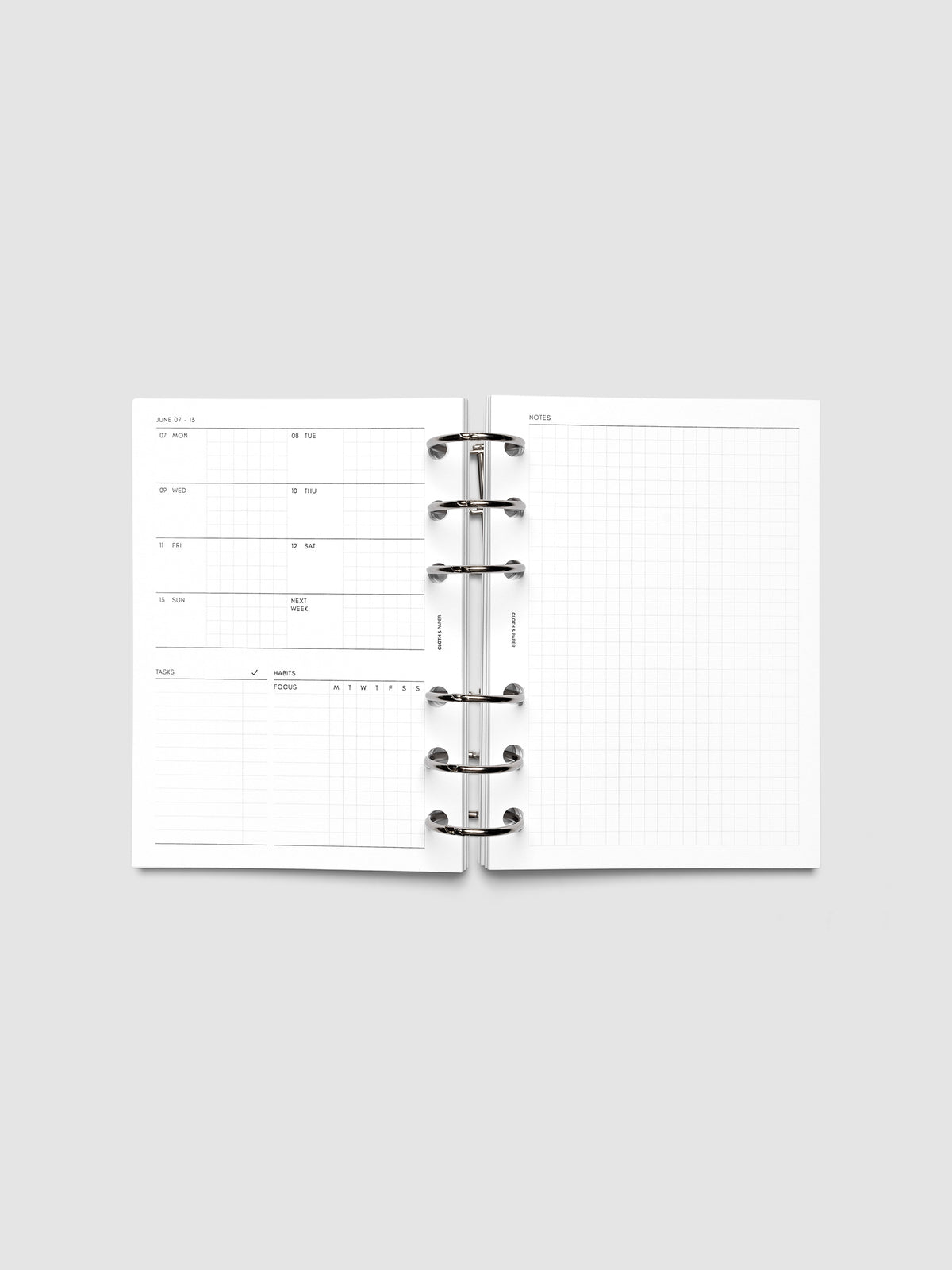 Open planner showing the full two-page 2027 Dated Weekly Admin spread in A6 6-Ring Punch size, with the weekly overview and task and habit tracking sections on the left and a graph notes layout on the right