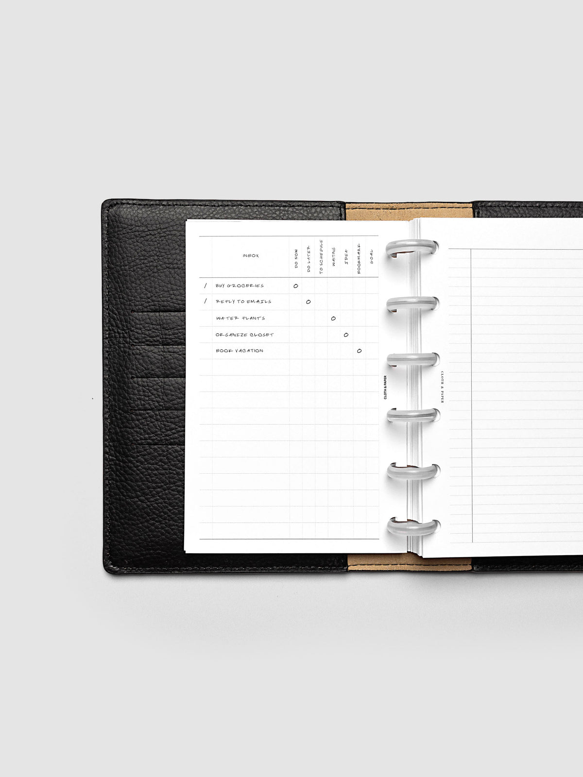 Demo page for Inbox Sorting Planner Inserts shown pre-punched for discbound CP Petite planners in a black folio.