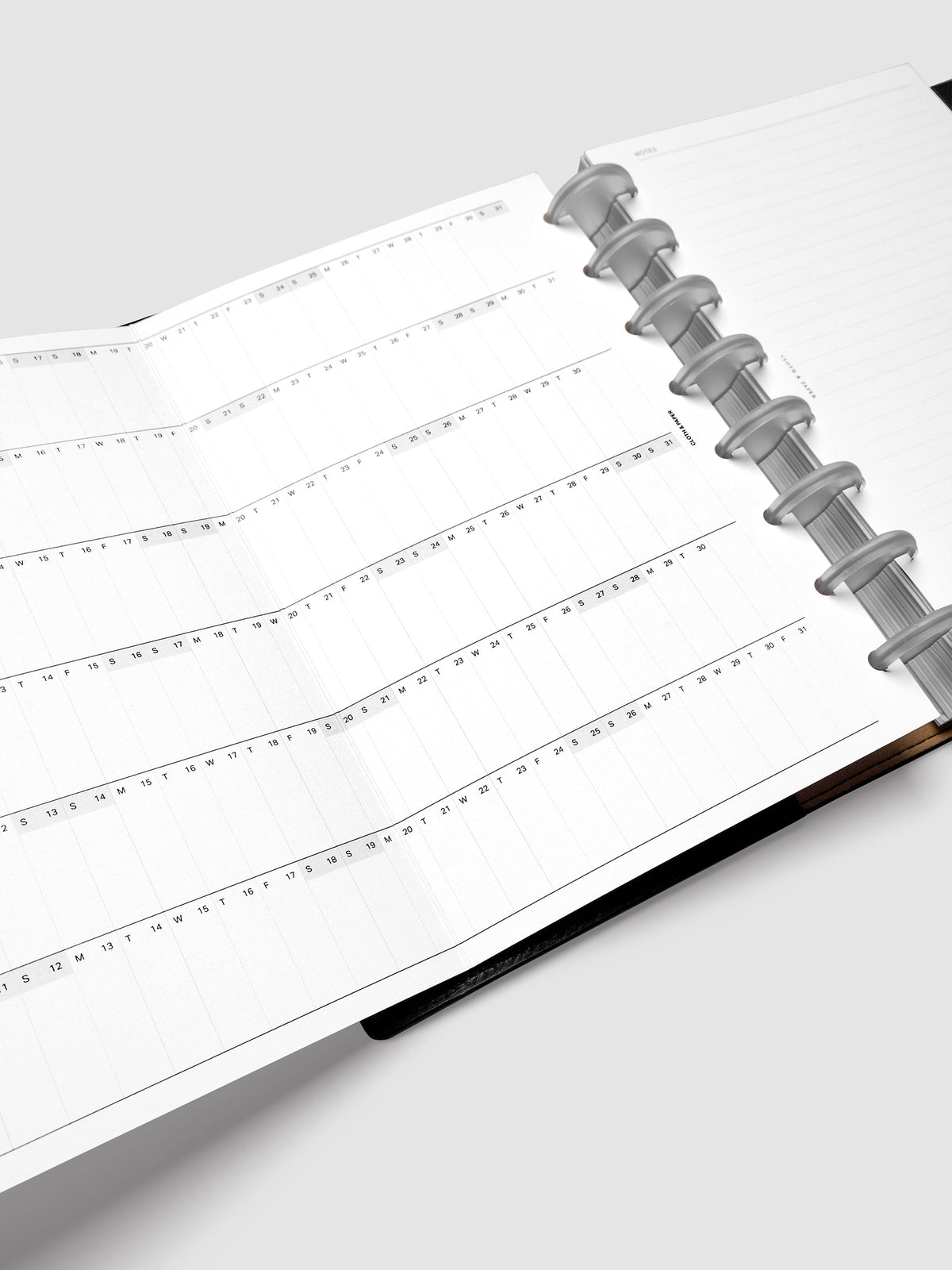 2027 Dated Fold Out Insert fully unfolded inside a Half Letter 8-Disc Punch discbound planner, showing six months of dated calendar boxes across one side.