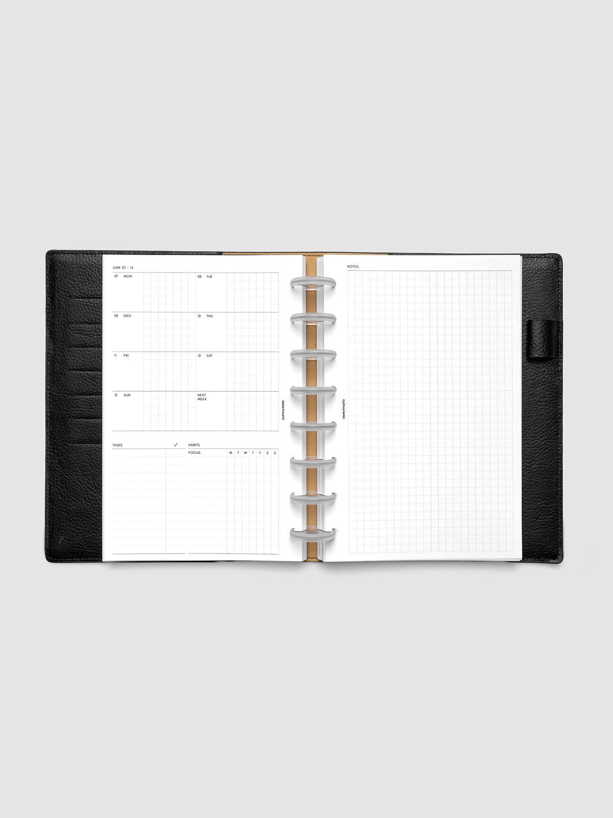 Open planner showing the full two-page 2027 Dated Weekly Admin spread in Half Letter 8-Disc Punch size, with the weekly overview and task and habit tracking sections on the left and a graph notes layout on the right