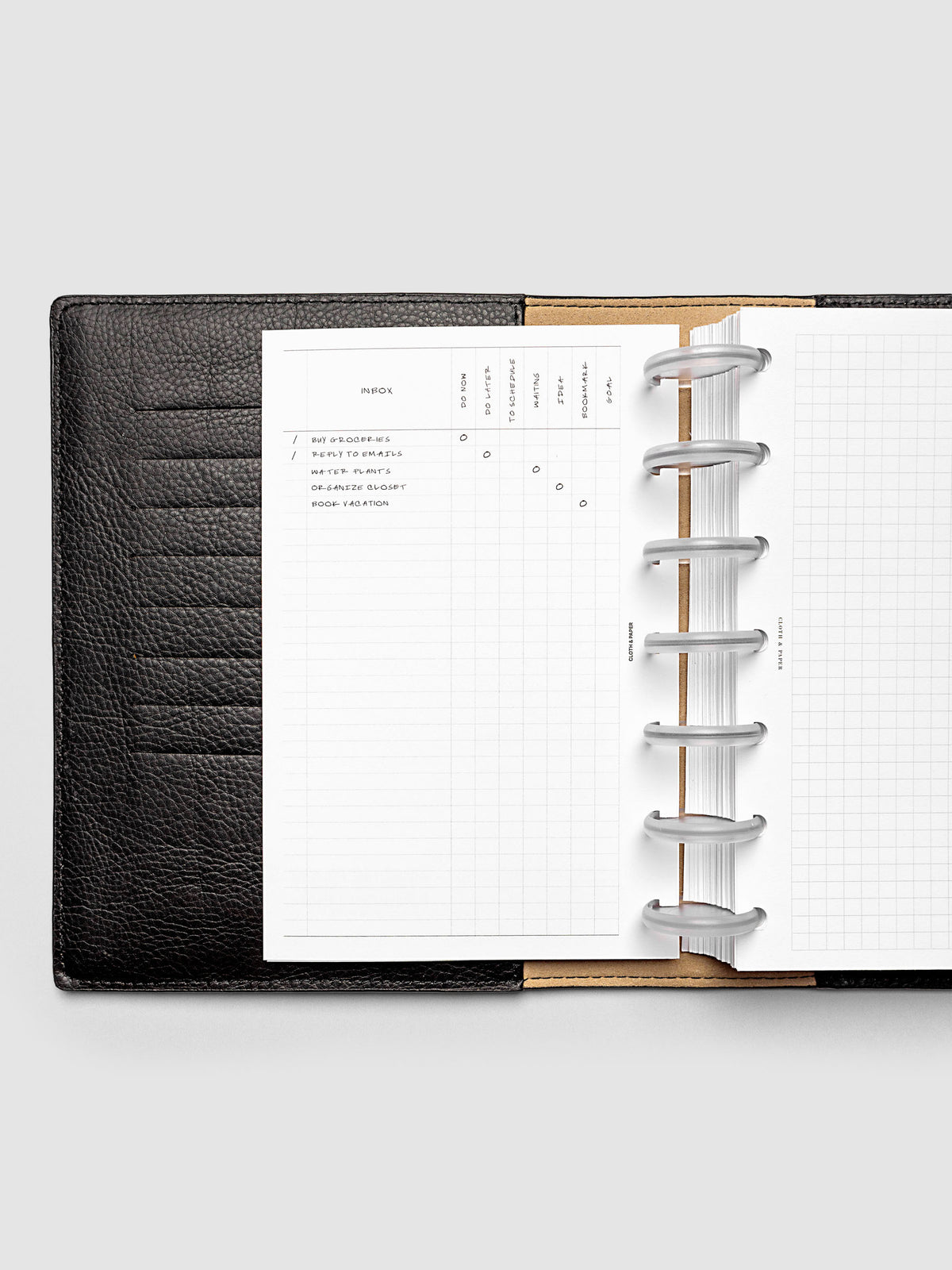 Demo page for Inbox Sorting Planner Inserts shown pre-punched for discbound HP Mini planners in a black folio.