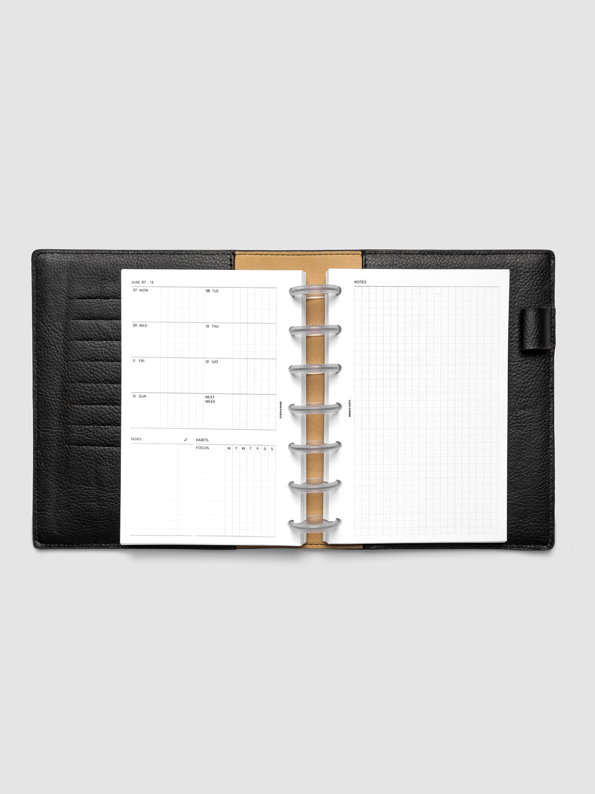 Open planner showing the full two-page 2027 Dated Weekly Admin spread in HP Mini 7-Disc Punch size, with the weekly overview and task and habit tracking sections on the left and a graph notes layout on the right