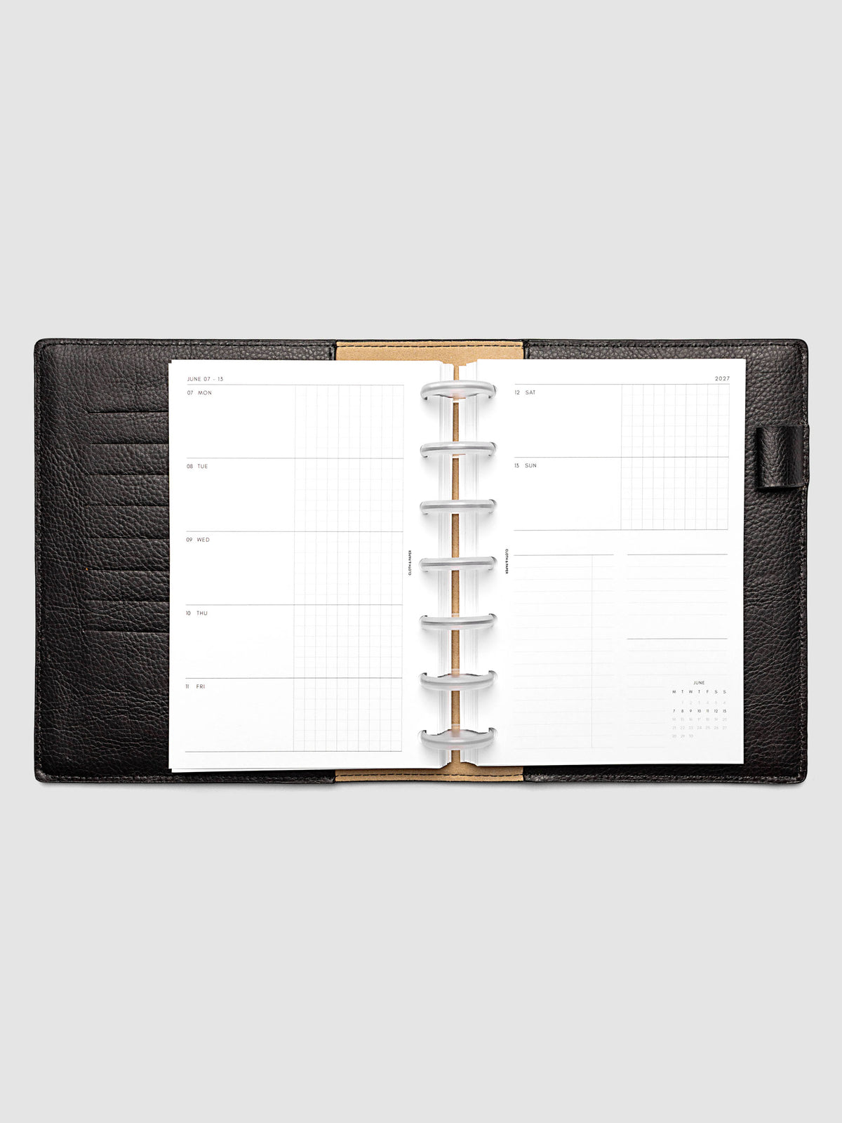 Open planner showing the full two-page 2027 Dated Weekly Horizontal Monday Start spread in HP Mini 7-Disc Punch size, with split open and graph daily columns on the left and weekend dates, tasks, notes, and mini monthly calendar on the right