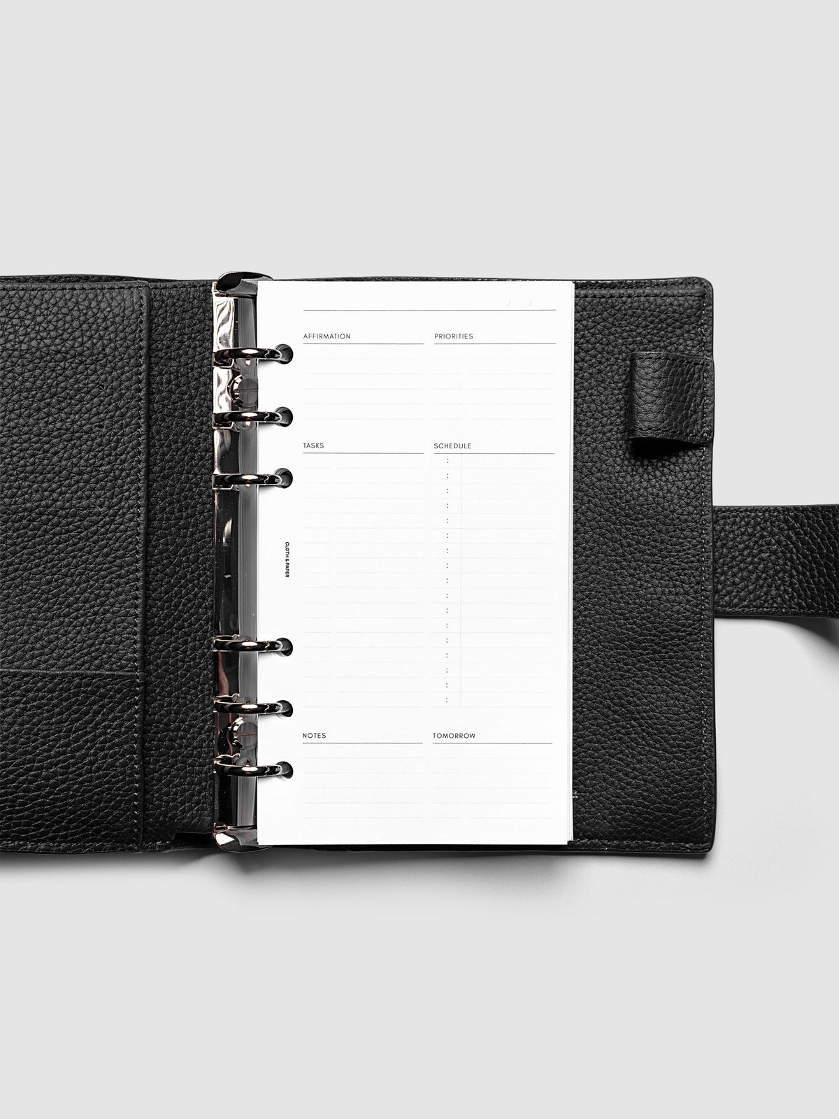 Daily Essentials Planner Inserts shown in size Personal inside a black agenda.