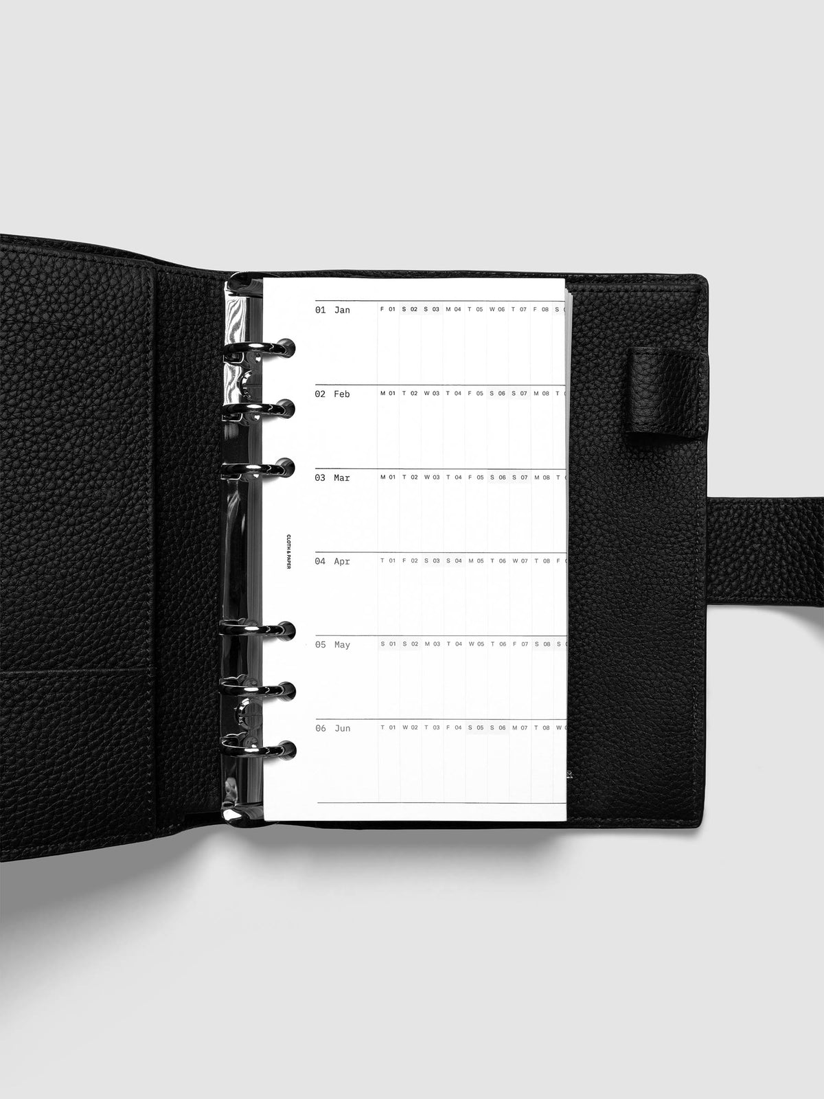 2027 Dated Fold Out Insert tucked into a Personal 6-Ring Punch 6-ring planner, shown closed.