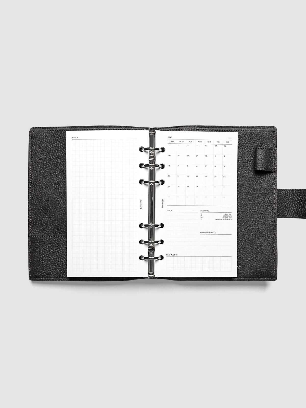 2027 Dated Monthly Admin Inserts open inside a Personal 6-Ring Punch 6-ring planner, showing the fully open graph left page alongside the Sunday start monthly calendar, task section, holiday reference, important dates, and next month preview on the right.