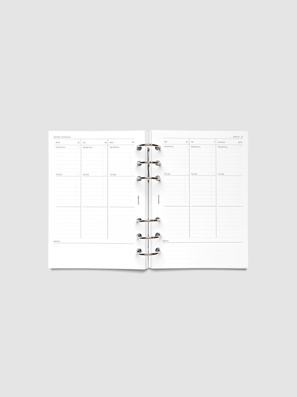 Both pages inside planner: 2027 Dated Weekly Task Planner Inserts, Monday Start, Personal Wide 6-Ring Punch, full week-on-two-pages spread showing blank vertical columns for each day with labeled priorities, to-do, and notes sections, Saturday and Sunday combined, and weekly notes section along the bottom, shown inside a planner