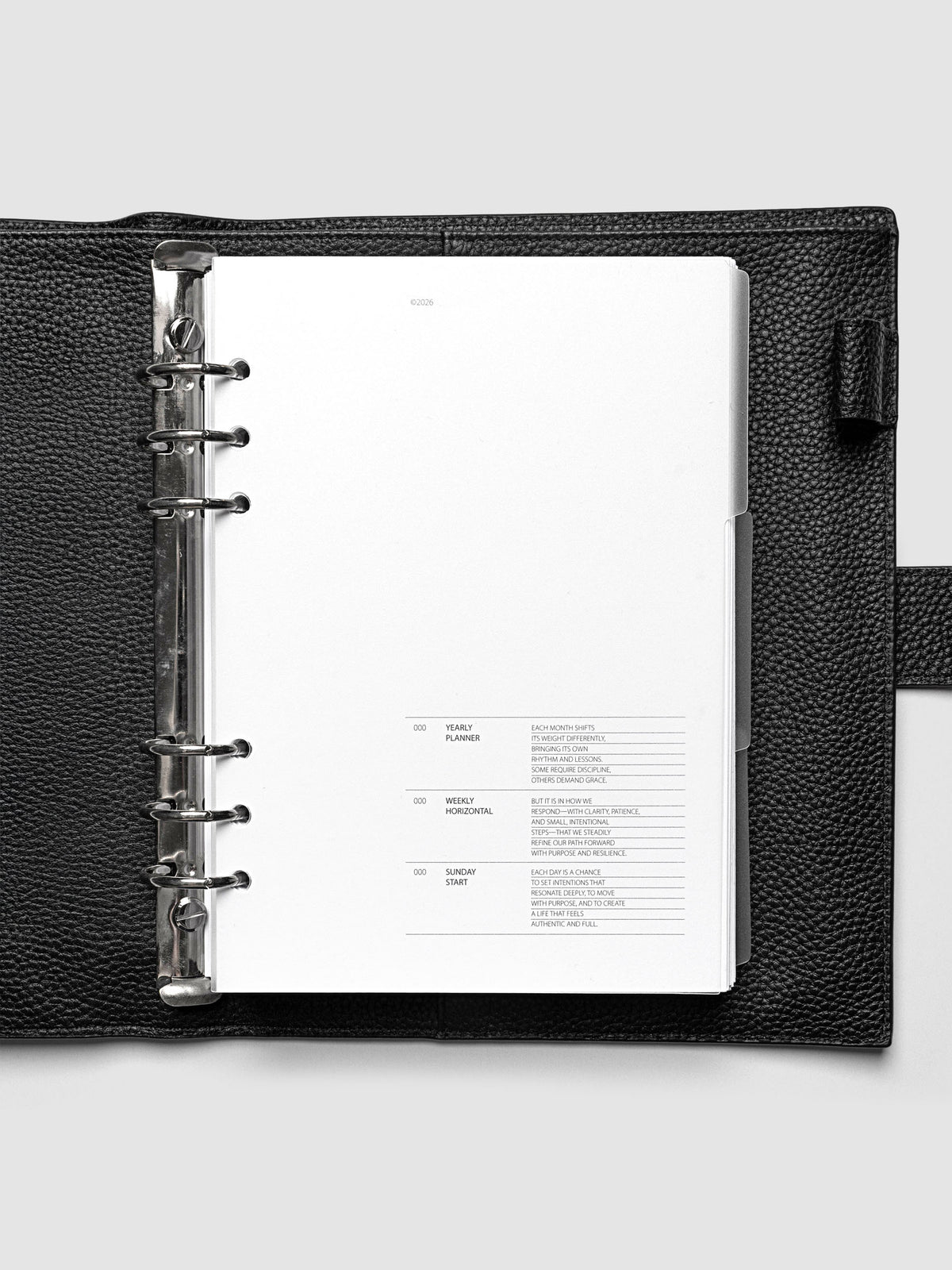 Blank, transparent side tab divider set shown in an A5 planner.