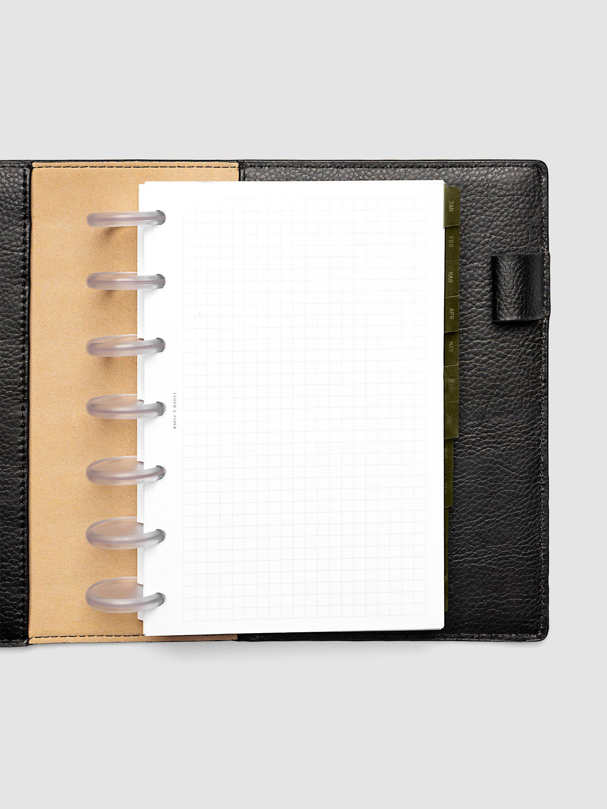 HP Mini 7-Disc Punch Ultra-Thin Monthly Dividers in olive green shown tabbed inside a planner