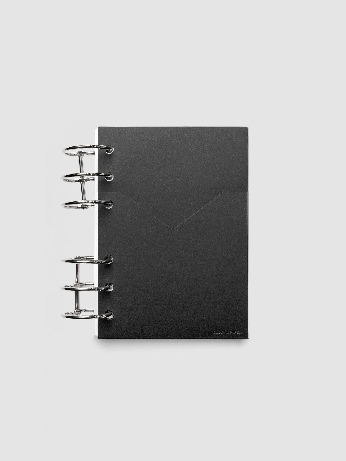 Black planner paper pocket folder shown inside a planner in size A6 6-Ring Punch