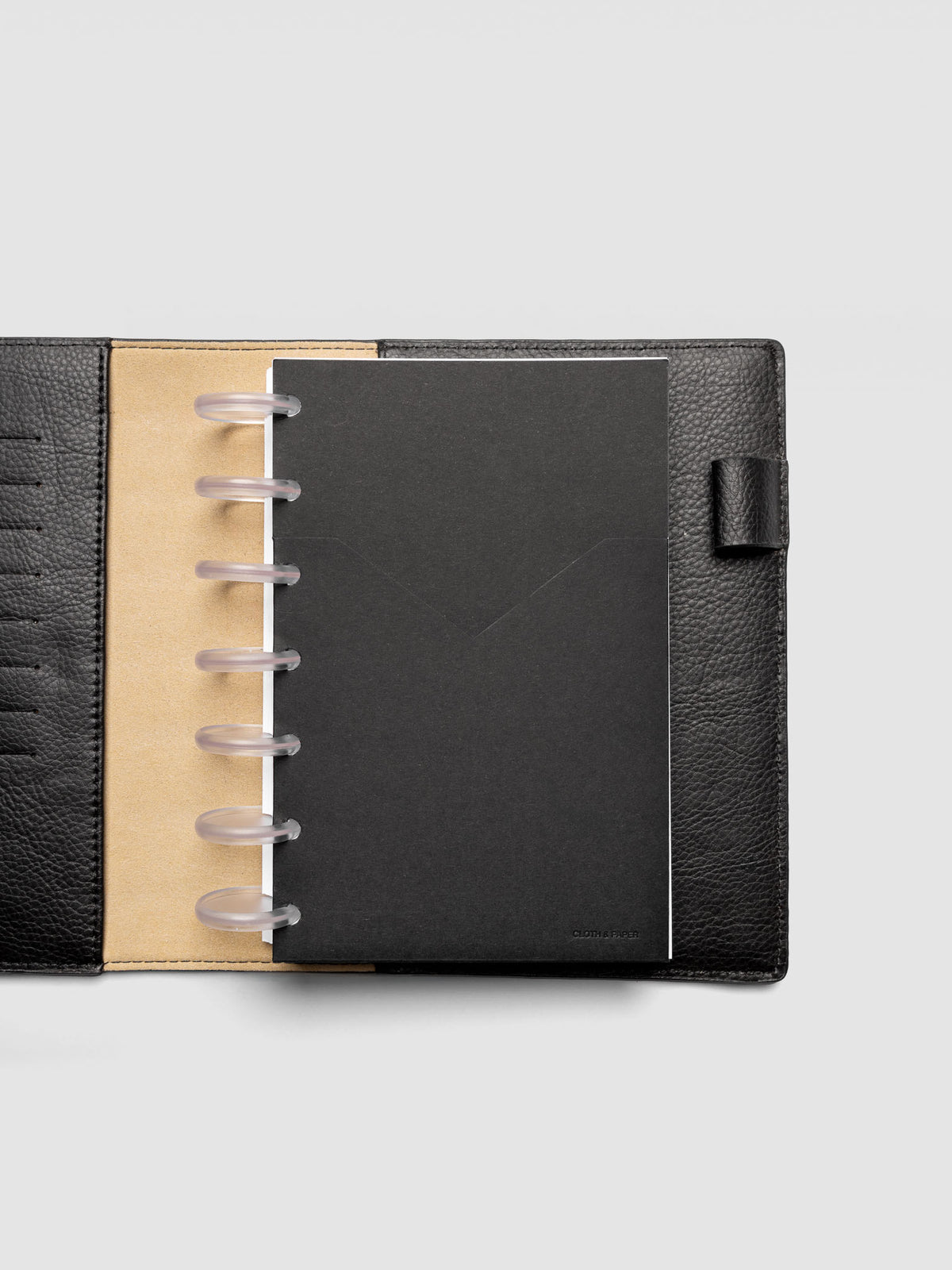 Black planner paper pocket folder shown inside a planner in size HP Mini 7-Disc Punch
