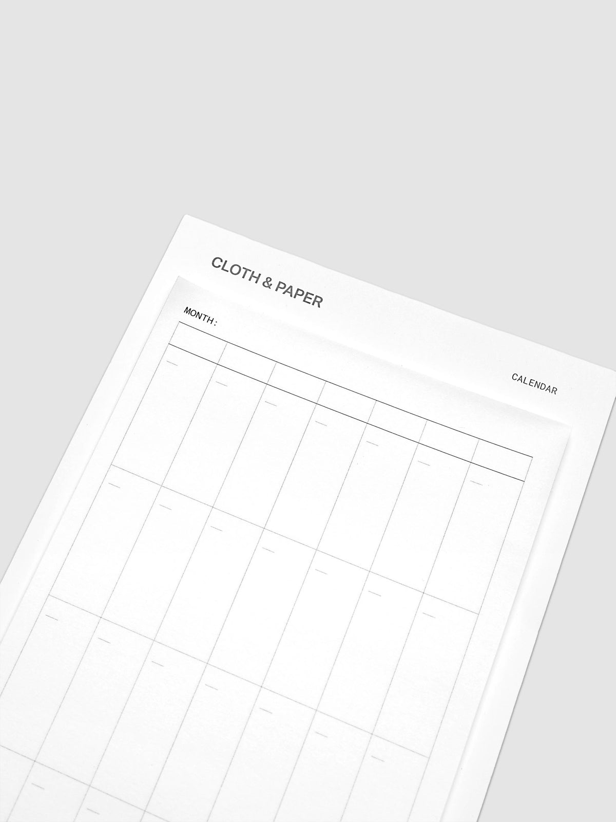 Top detail of undated monthly calendar sticky note showing header and date grid