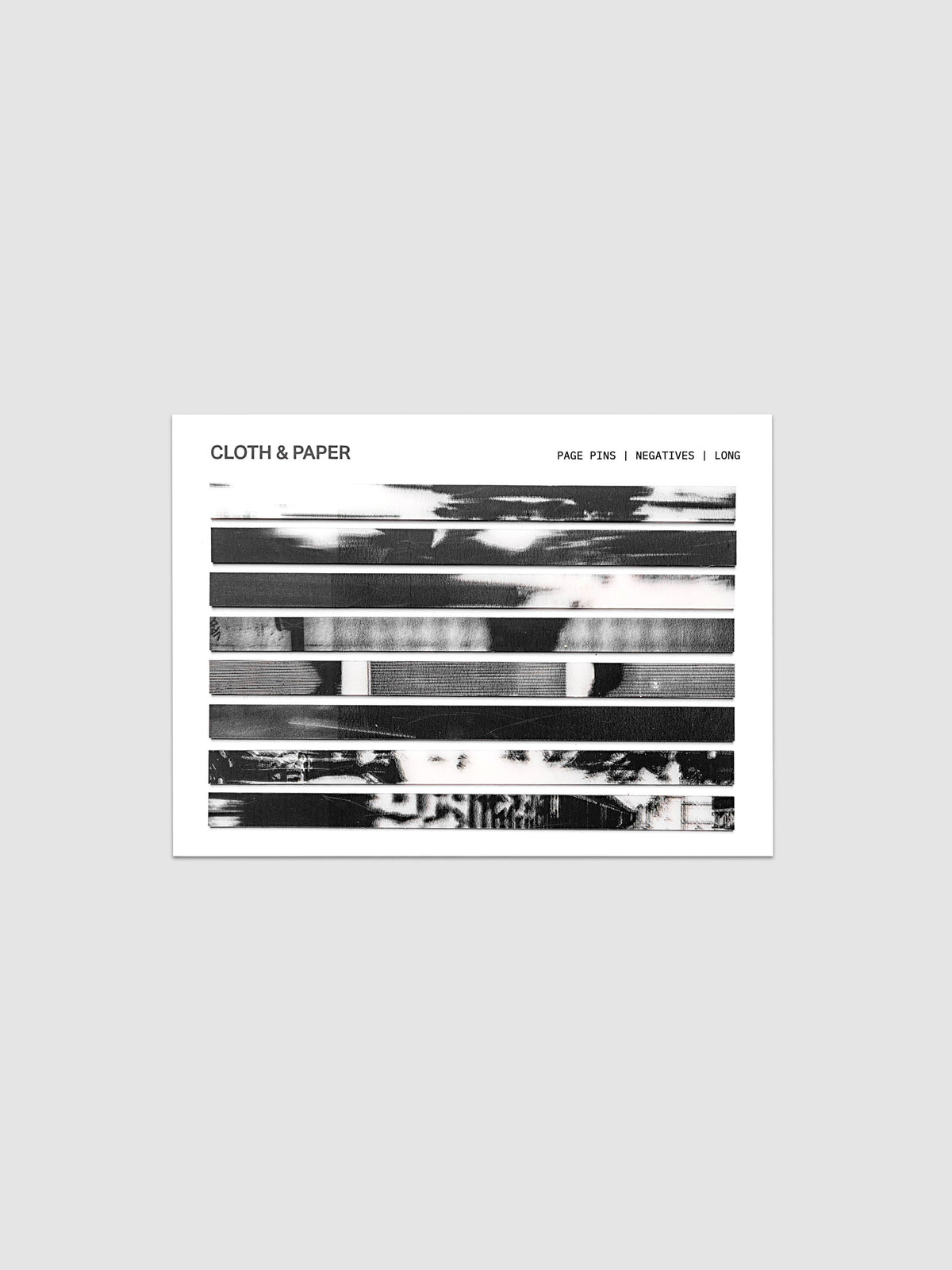 Page Pins | Long | Negatives, full set of 160 transparent grey-toned film negative-style page pins on a white backing card