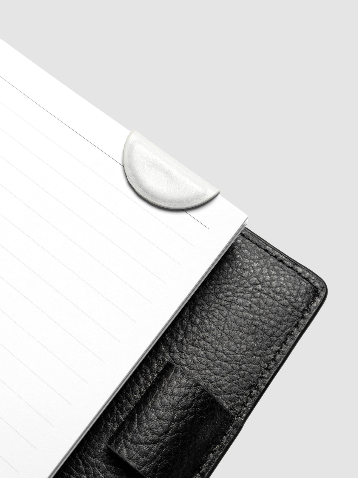 Aspen (white) mini magnetic bookmark folded in half over planner pages