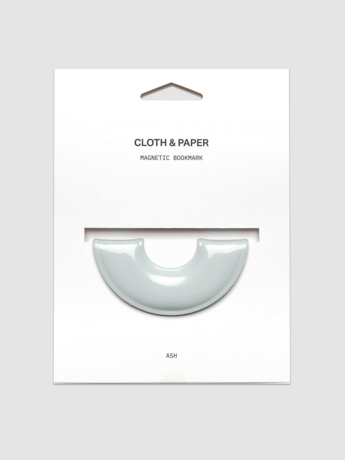 Magnetic Bookmark | Spotlight in the color Ash, a light grey, shown on a backing card