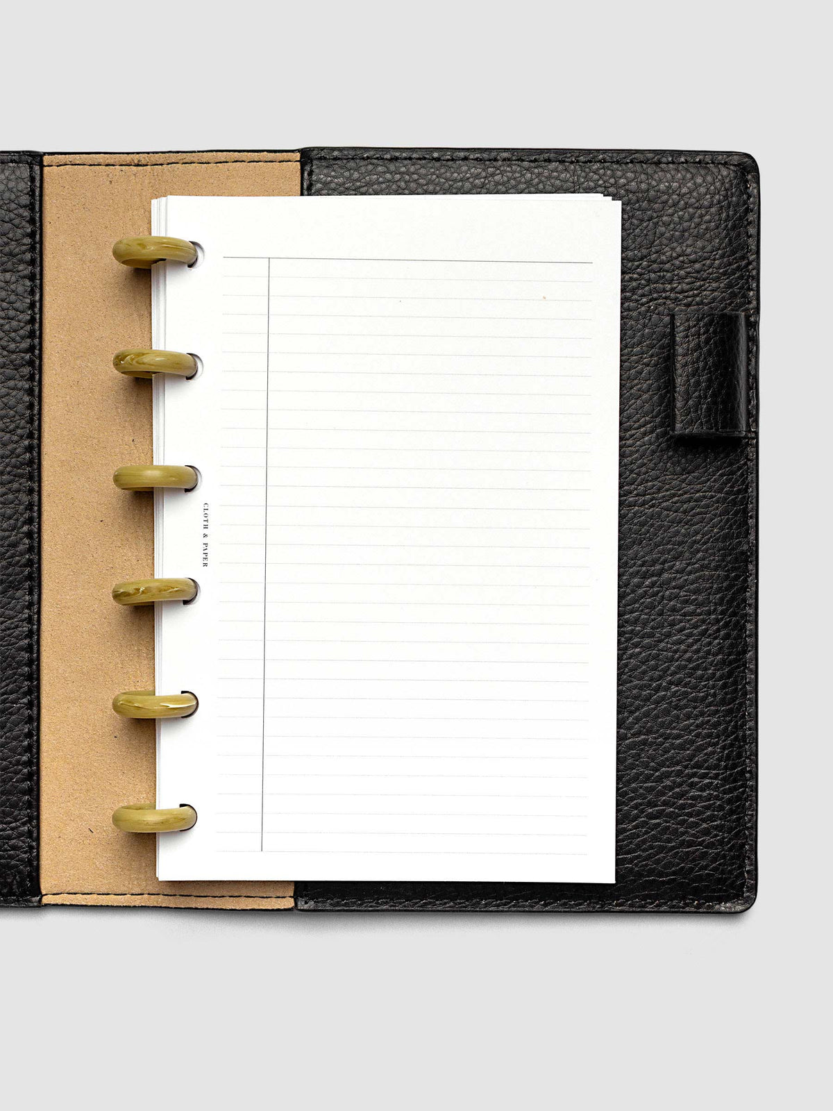Carrara Verde 0.75" planner discs in use on an open discbound planner with pages secured on the discs
