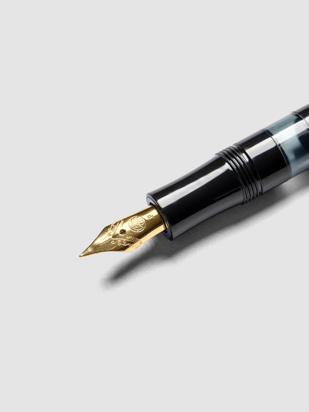 Gold plated steel nib on a black fountain pen.