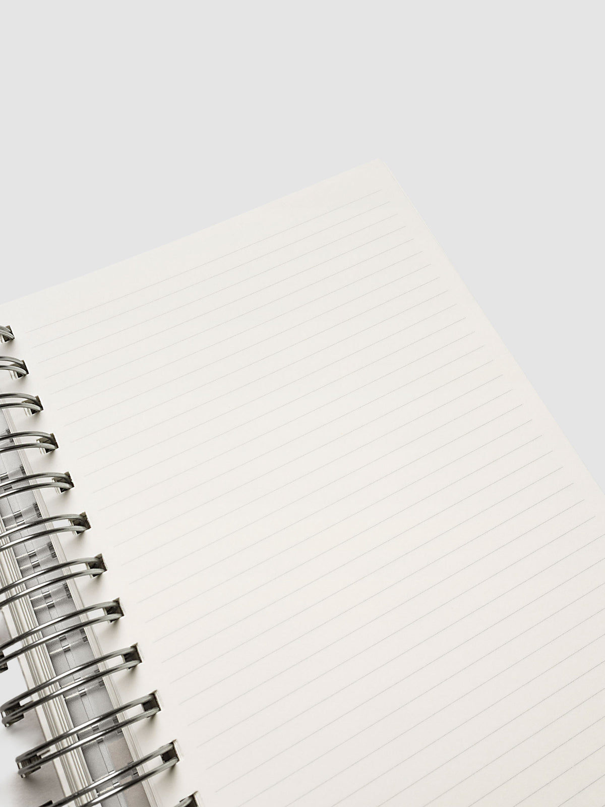 5 Subject Notebook A5 Punch close up of cream lined page corner with silver spiral binding