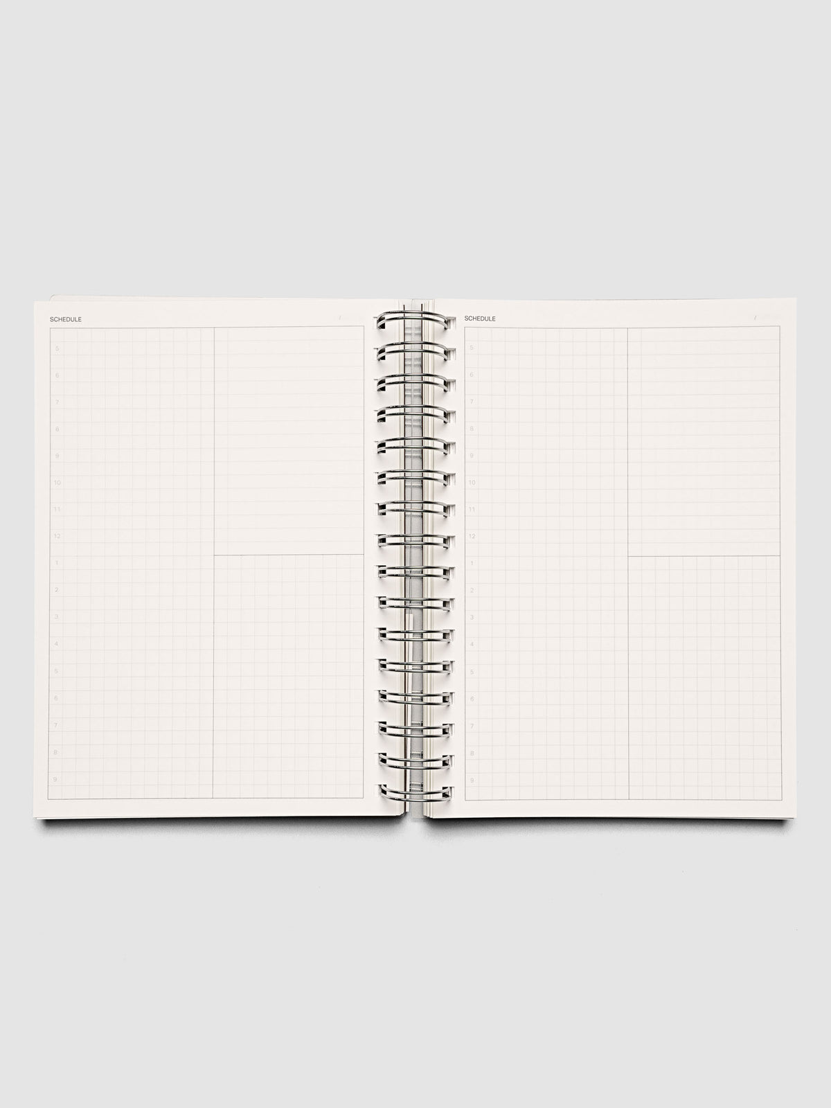 Spiral Notebook in size A5 and color Espresso brown with Daily Time Block interior pages shown open.