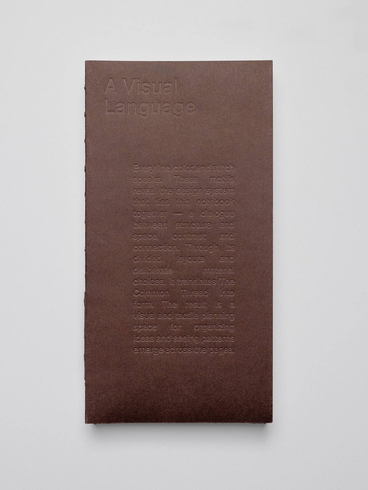 One Common Thread Notebook showing the dark brown cover.