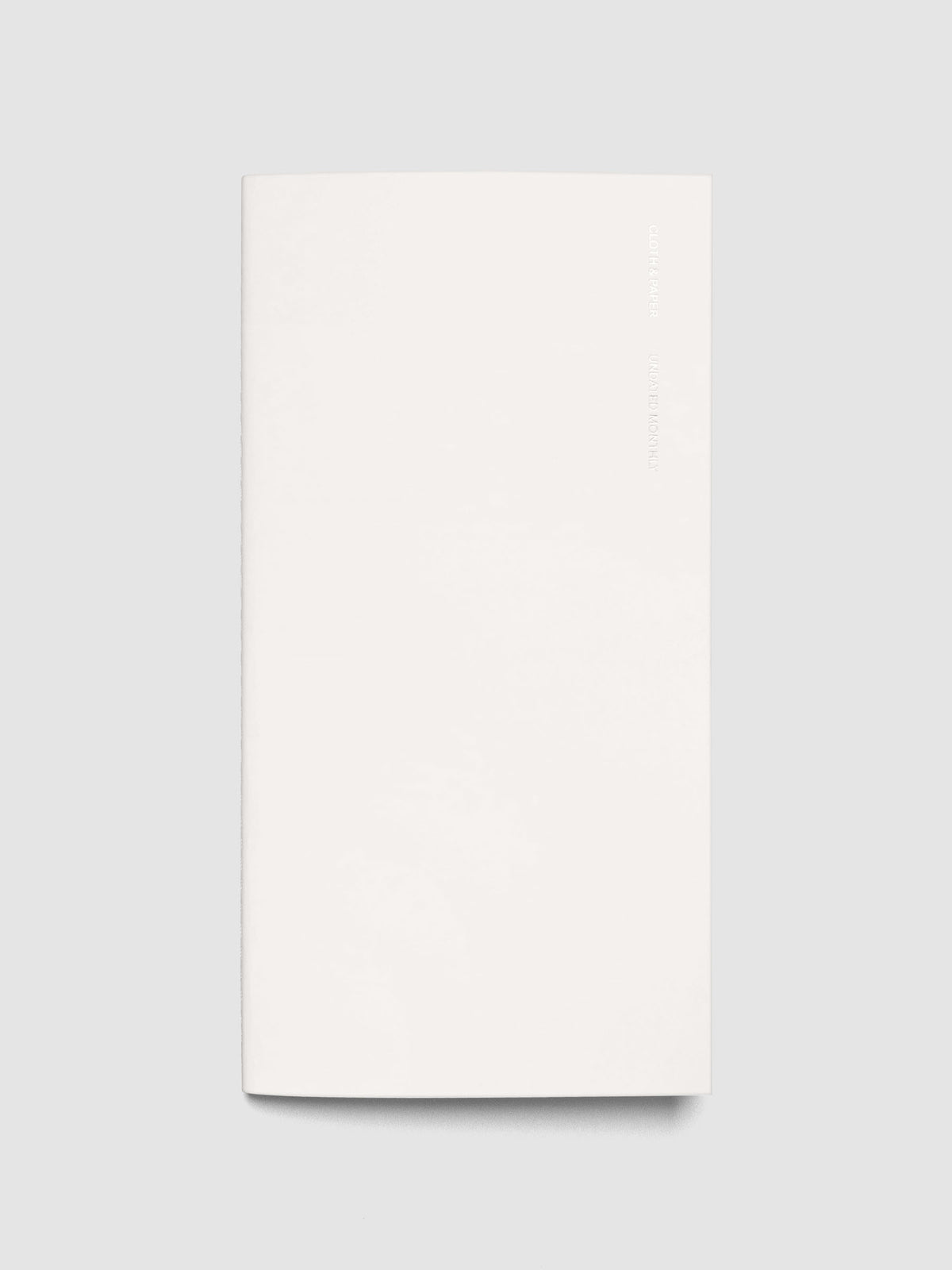 Exterior of a white pocket plus sized travel notebook.