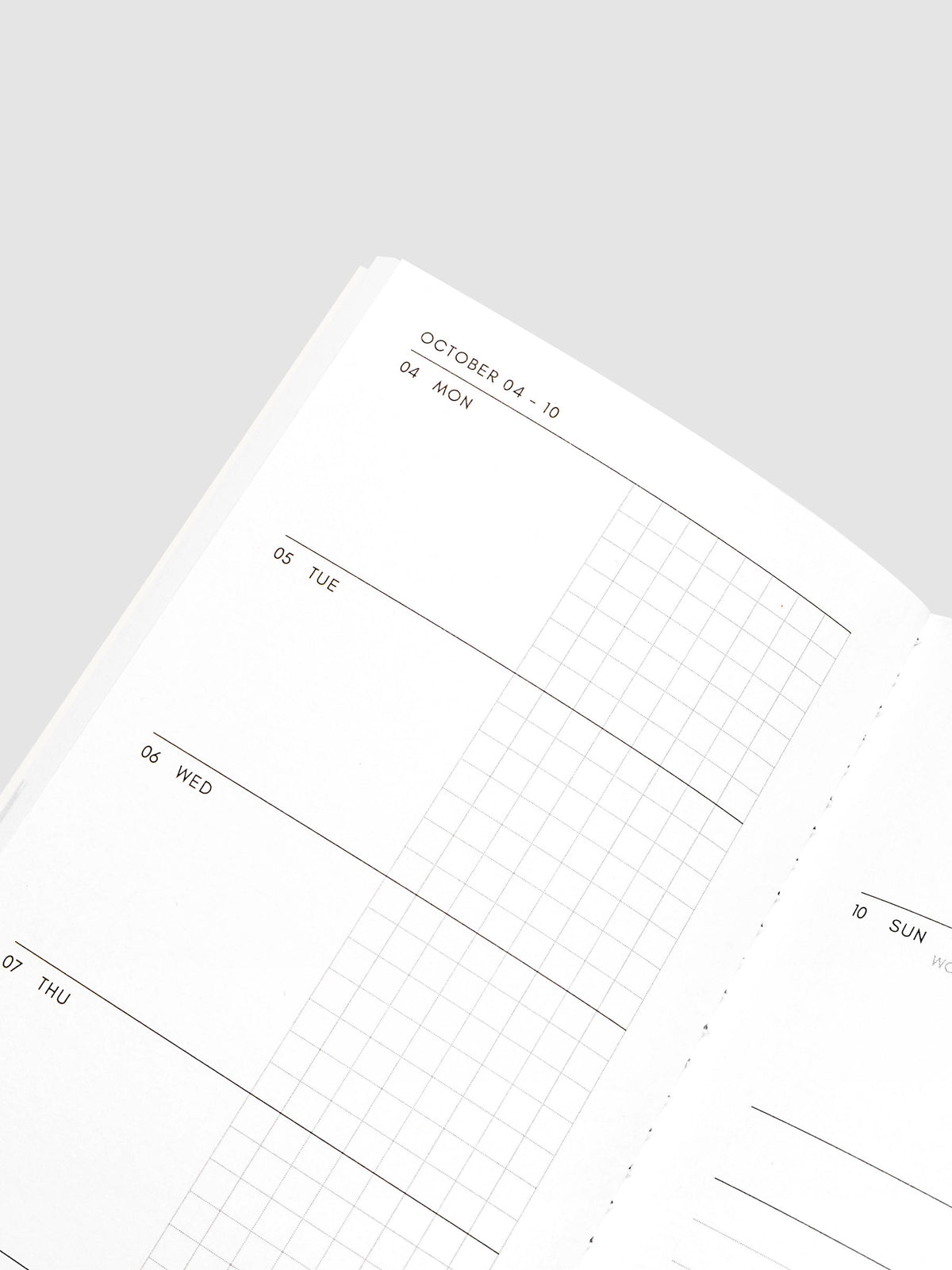 Close-up of the top of the left page of the Jul–Dec 2027 Dated Travel Notebook, showing the split daily columns with open space and graph sections