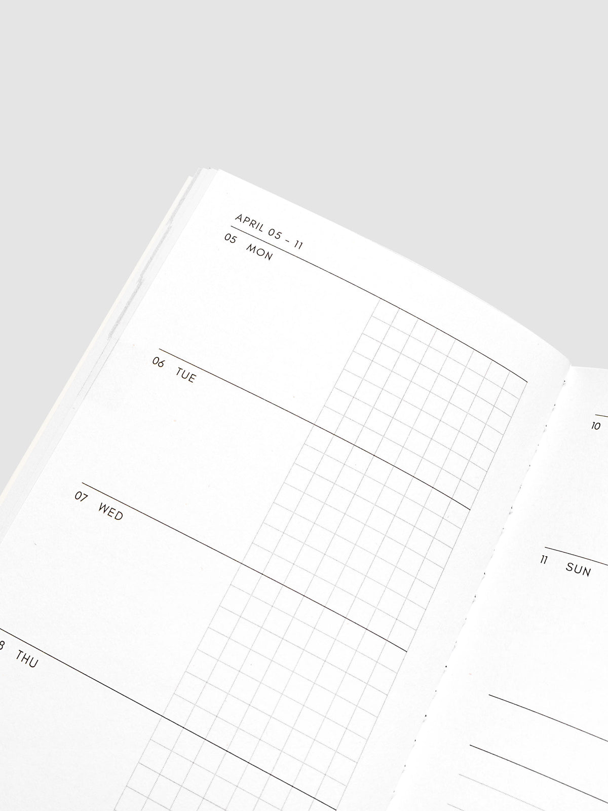 Close-up of the top of the left page of the Jan–Jun 2027 Dated Travel Notebook, showing the split daily columns with open space and graph sections