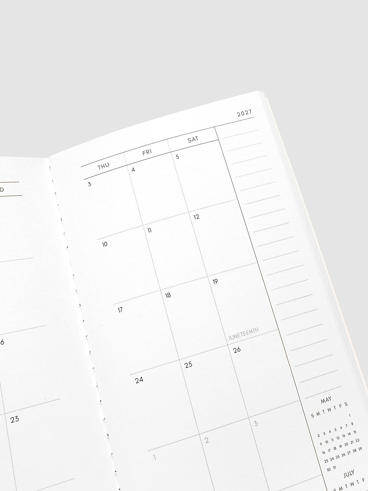 Close-up of the top of the right page of the 2027 Dated Travel Notebook Monthly in Pocket Plus size, showing the dated calendar grid and notes section