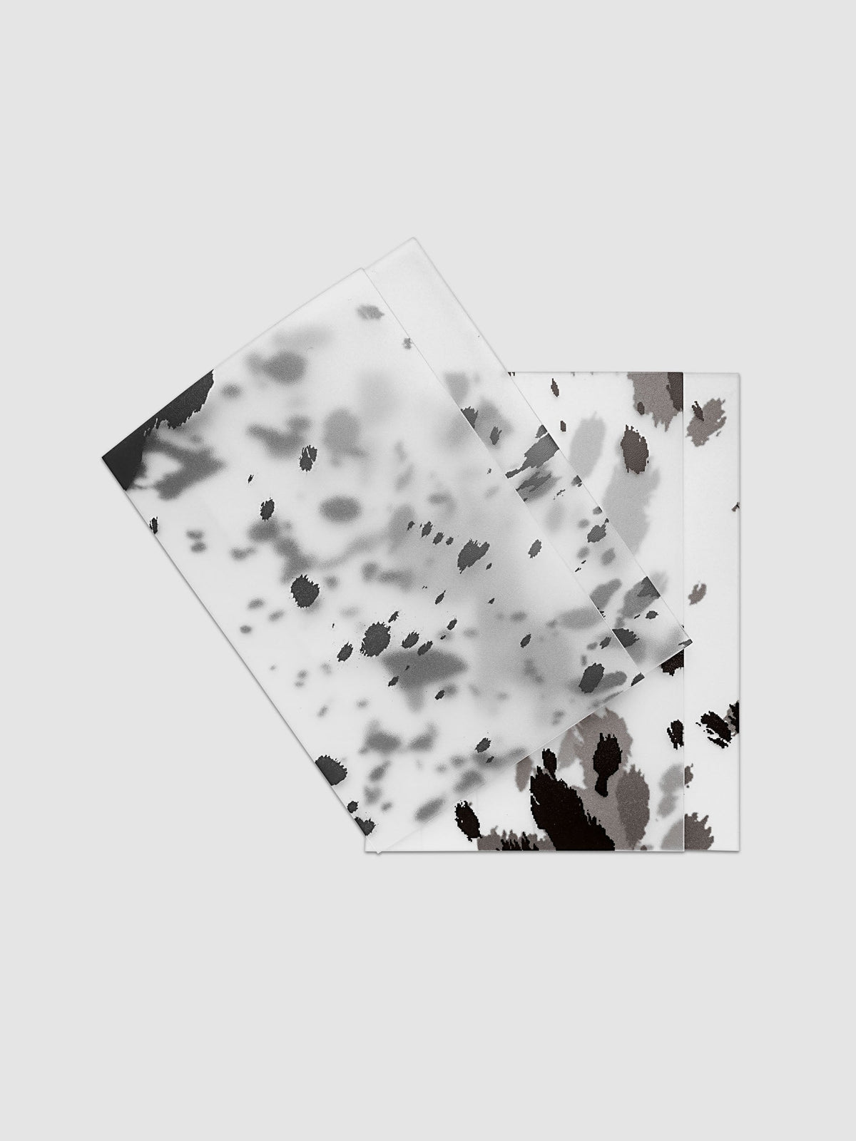 Two CP Petite frosted plastic notebook covers with dalmatian animal print pattern stacked and offset, shown in black and brown
