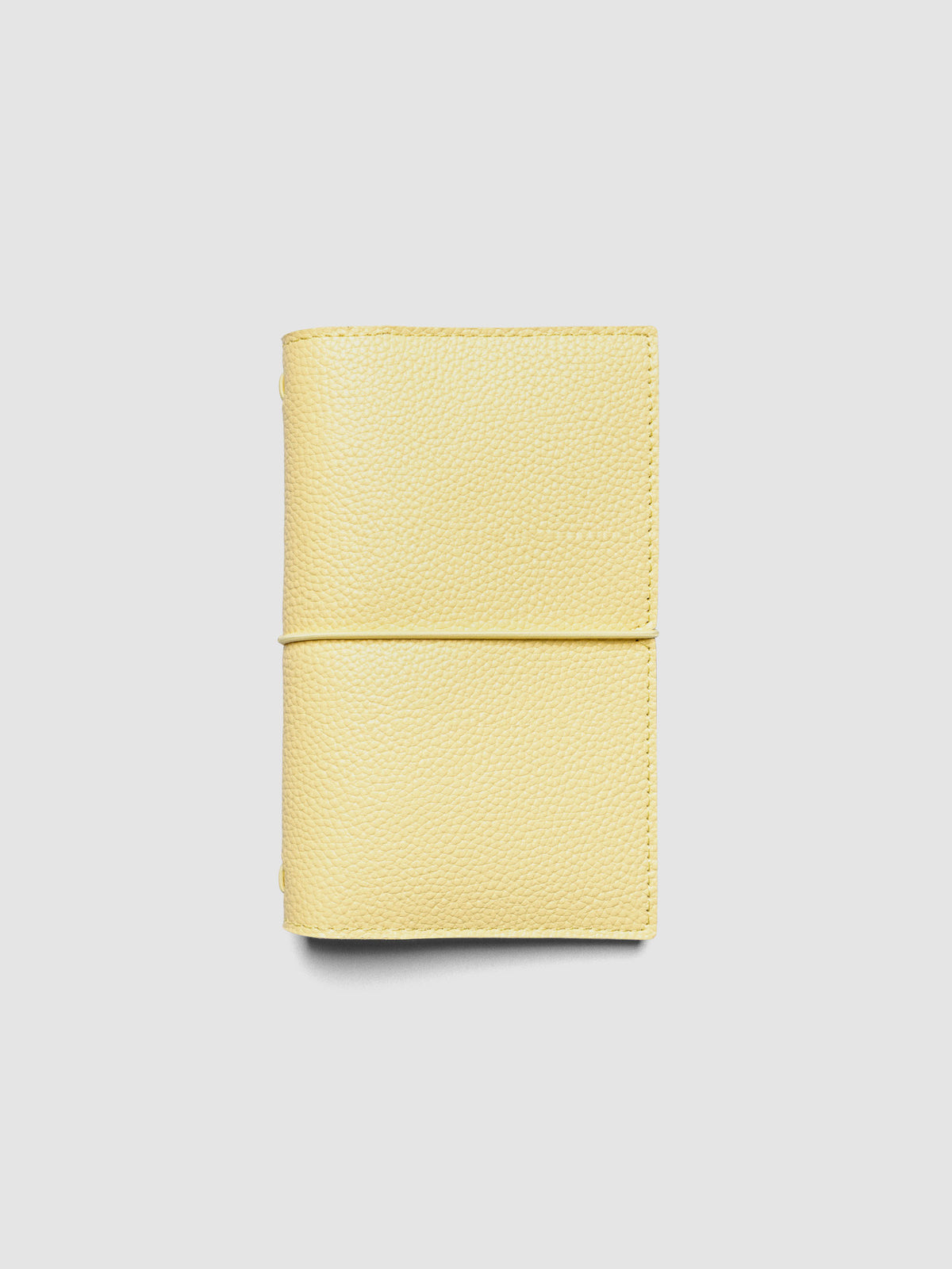 Butter yellow genuine leather travel notebook cover shown in size Pocket Plus.