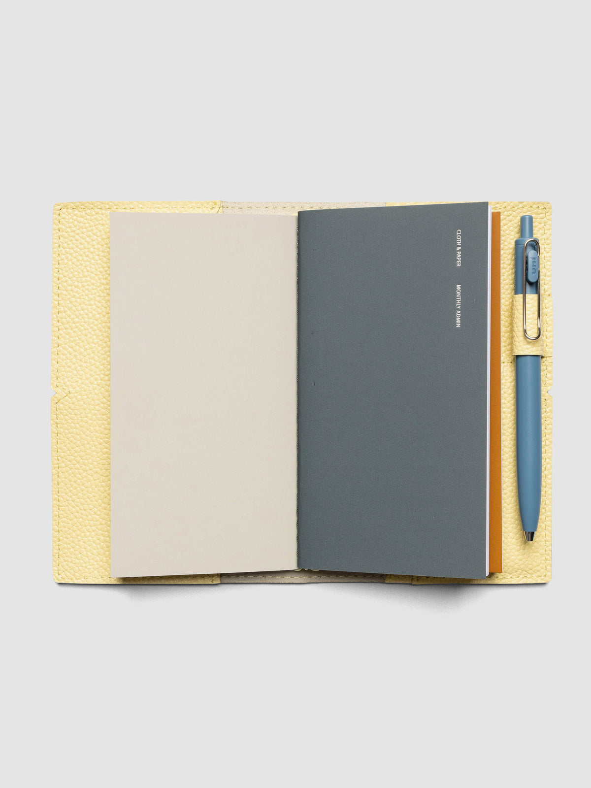 Butter yellow leather travel notebook cover in size Pocket Plus shown closed.