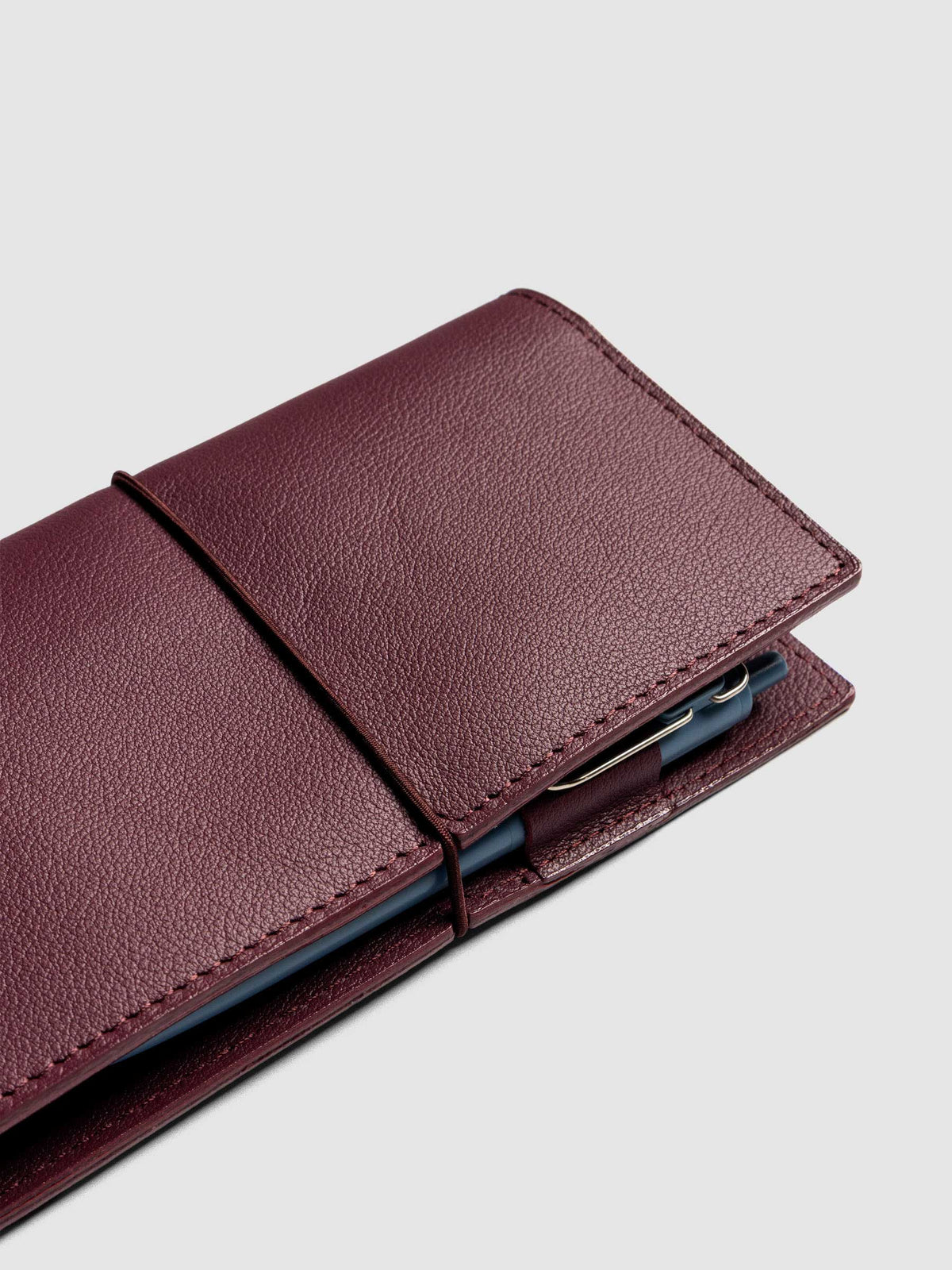 Deep red leather travel notebook cover in size Pocket Plus shown closed.