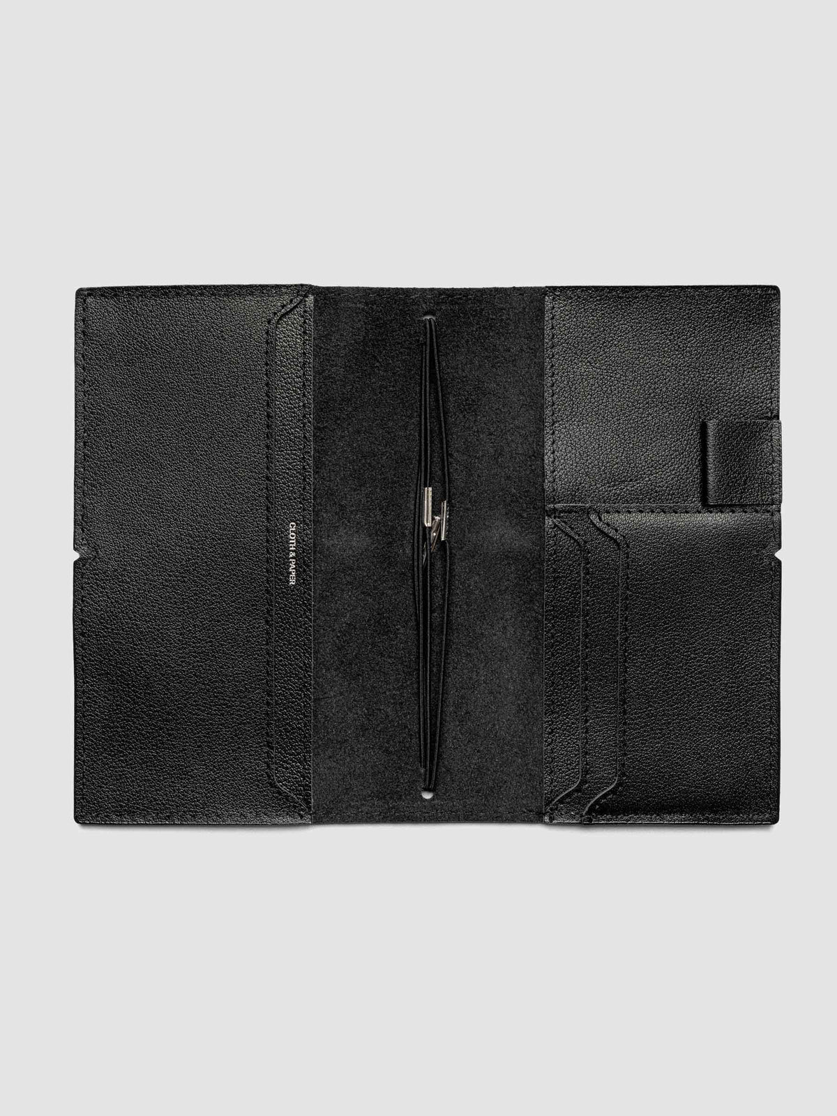 Black leather travel notebook cover in size Pocket Plus shown open with interior pockes and elastic bands.
